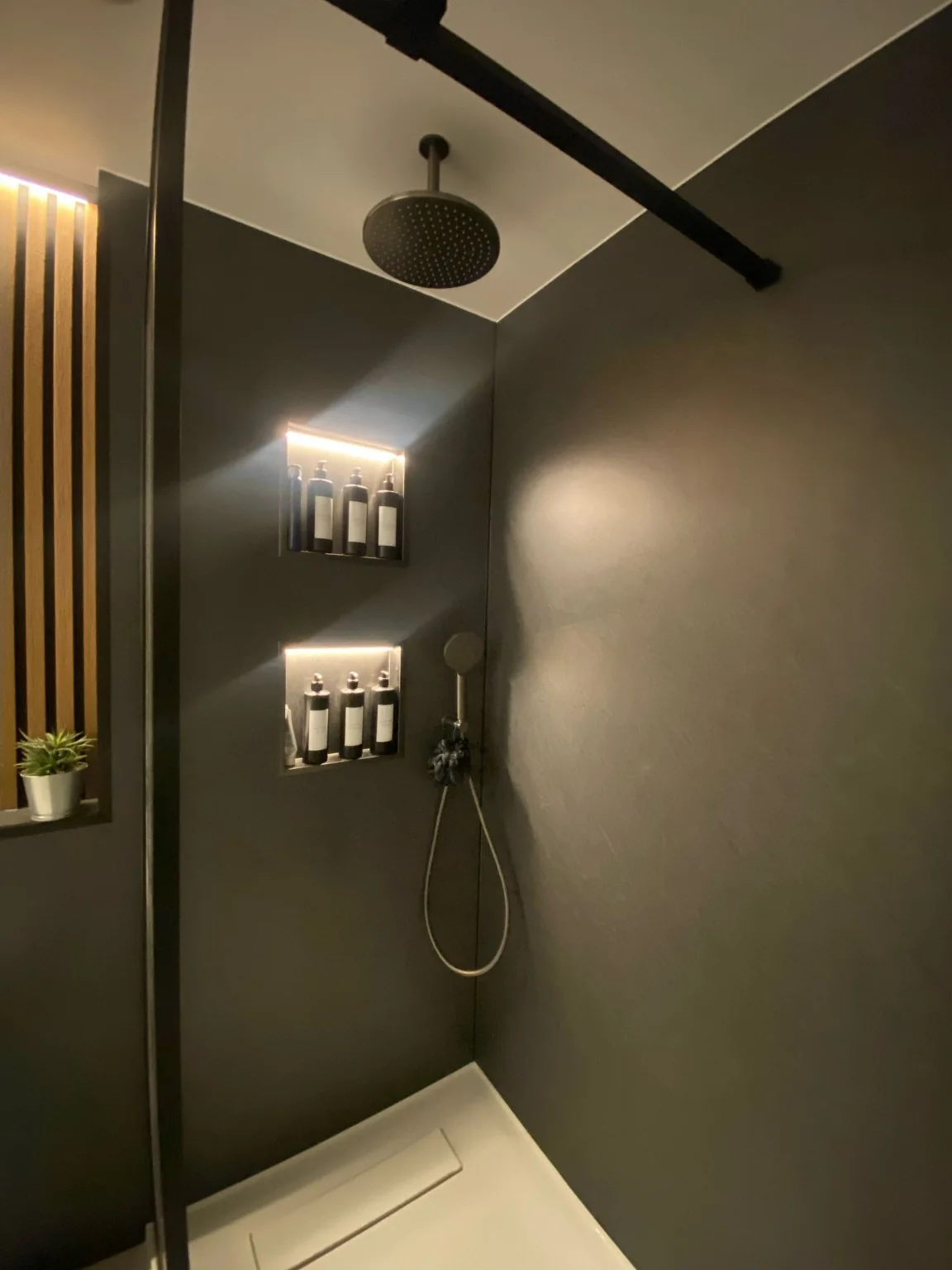 Completed contemporary dark shower room